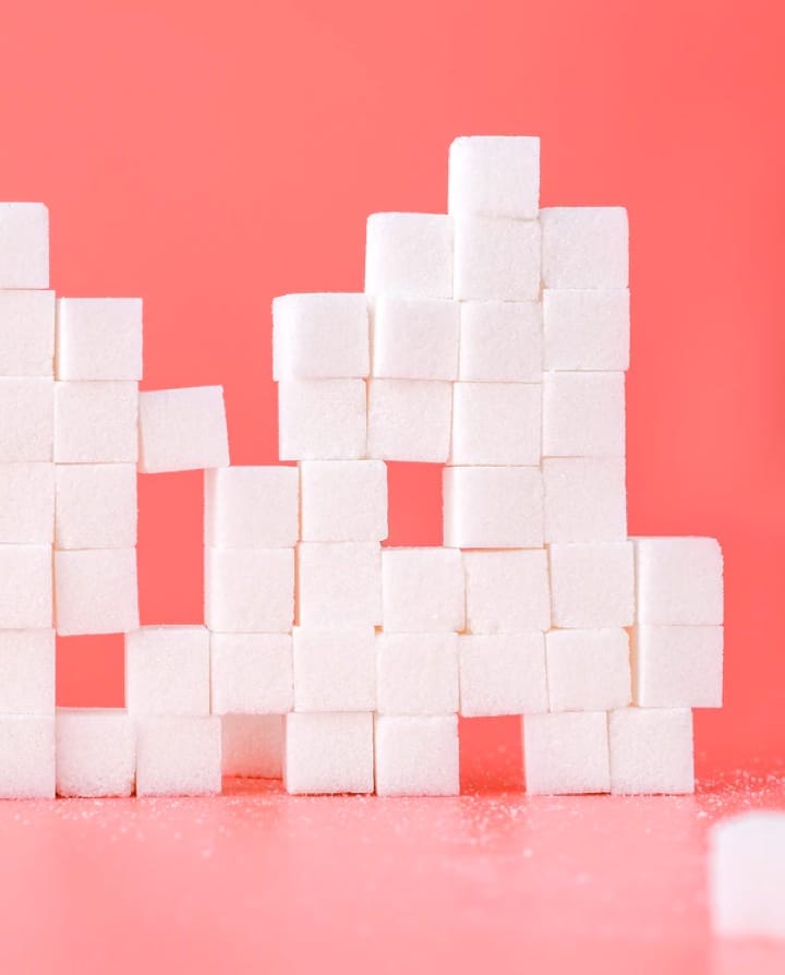 many sugar cubes on a pink background